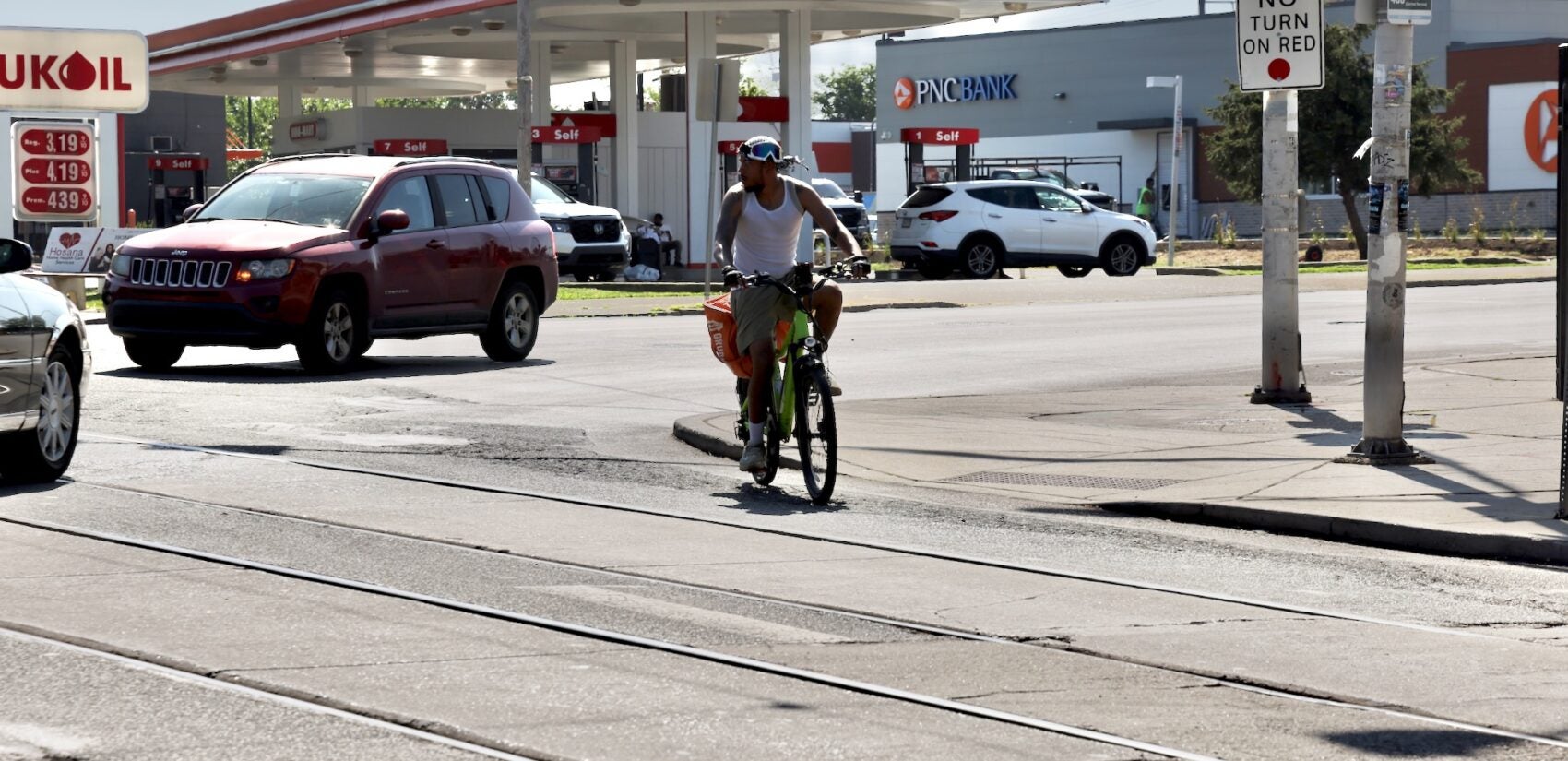 2025 06 25-e lee-philadelphia cobbs creek-dangerous intersection cyclist maneuvers A cyclist warily negotiates the intersection of Baltimore Avenue and 58th Street