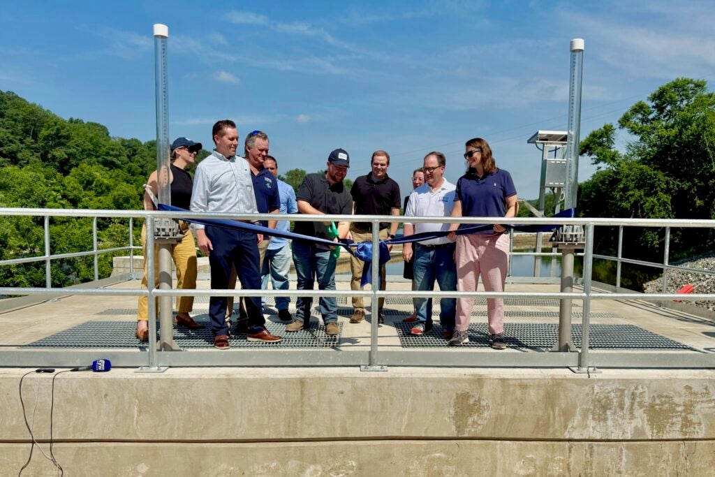 Officials opening the gate on the dam