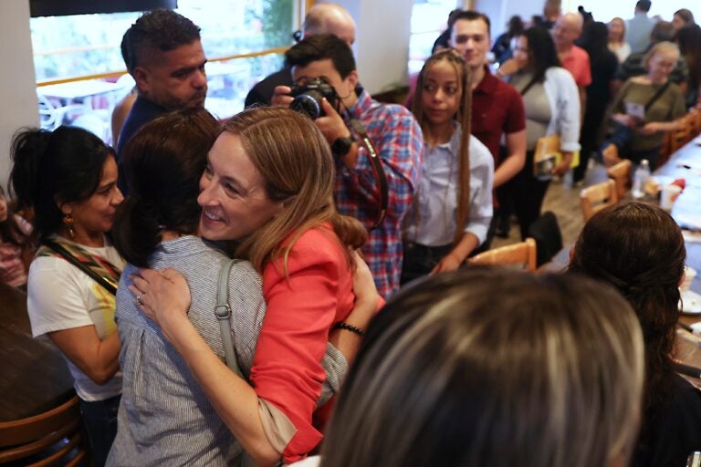 Mikie-Sherrill-2025-06-07 Mikie Sherrill hugs a voter