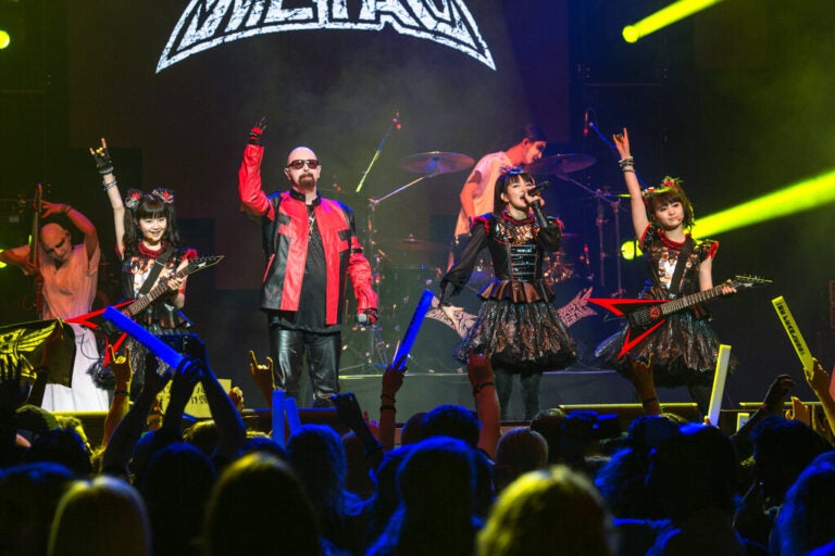 Yui Mizuno, Suzuka Nakamoto, Moa Kikuchi, and Rob Halford Members of the band BABYMETAL perform on stage