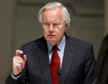 Bill Moyers speaking at a microphone
