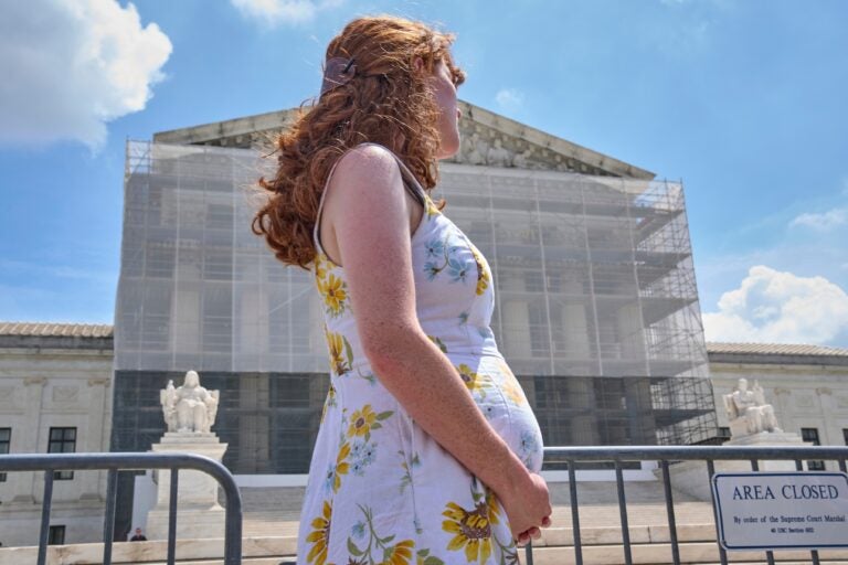 birthright-citizenship-protest-supreme-court-2025-05-15 A pregnant U.S. citizen stands at a protest for birthright citizenship