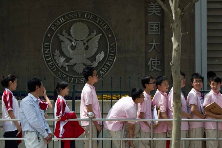 China US Explainer Students waiting in line in front of the Embassy