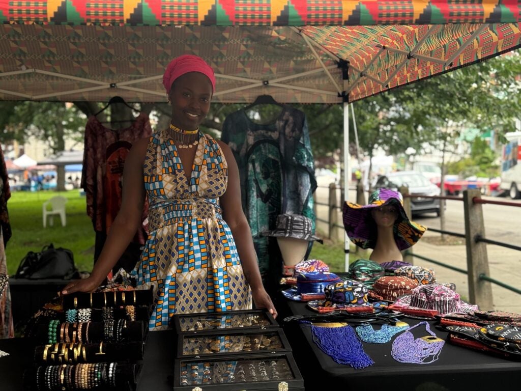 Deana Lucas poses next to her African-inspired clothing
