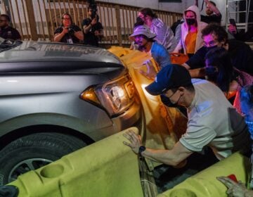 Protesters attempt to block a vehicle from leaving the Delaney Hall Detention Facility during protests