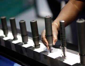 A row of gun silencers on display