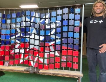 Kevin Aster Young posing with artwork