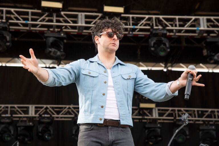 Low Cut Connie Adam Weiner on stage holding his hands up to the crowd