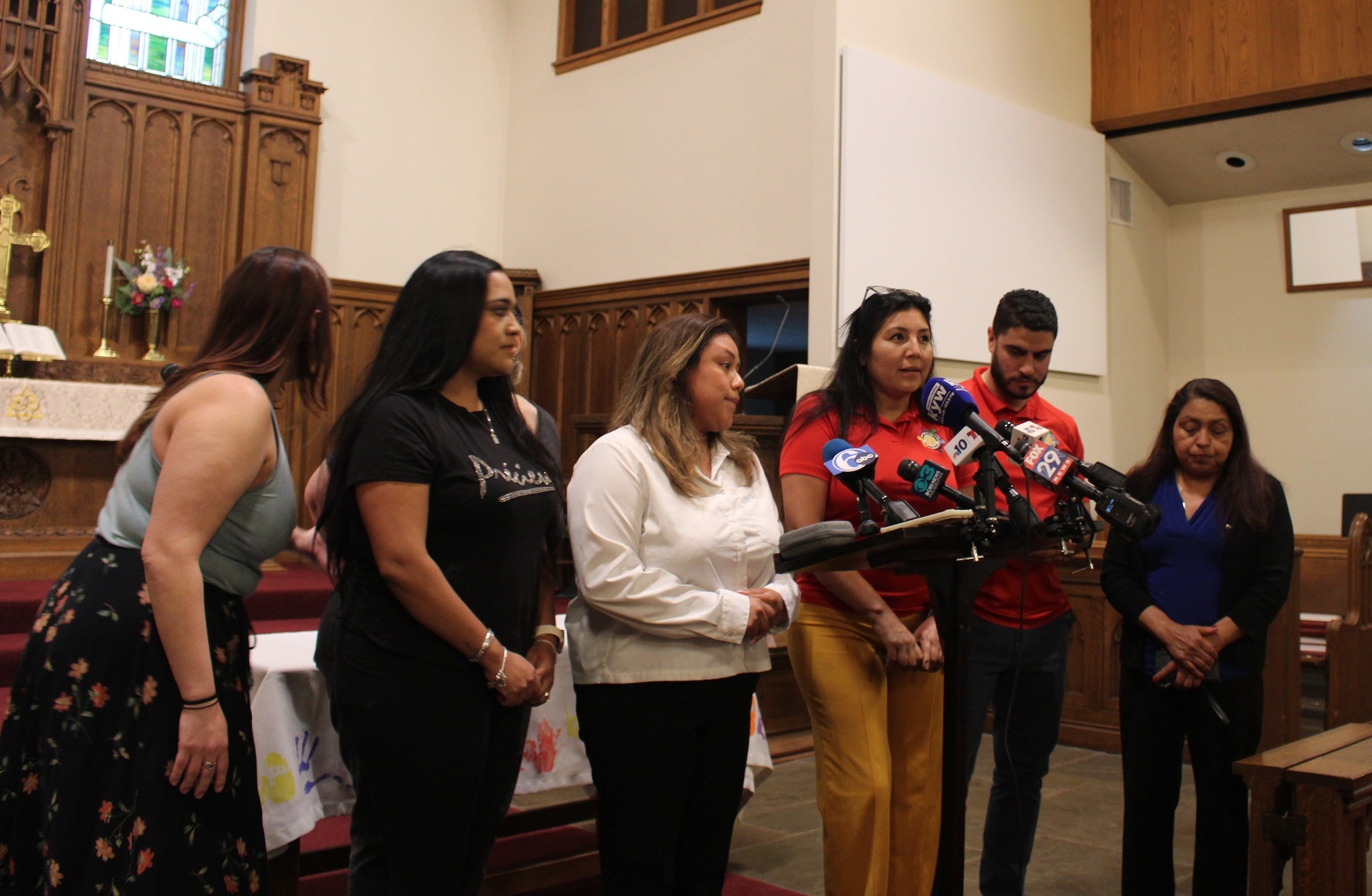 Immigrant advocates and family members of people who have been detained by ICE in the Norristown area speak in a church
