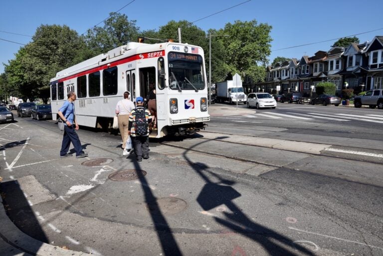 People boarding trolley at 58th Street and Cobbs Creek Parkway