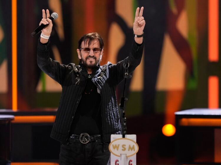 Ringo Starr holds up the peace sign
