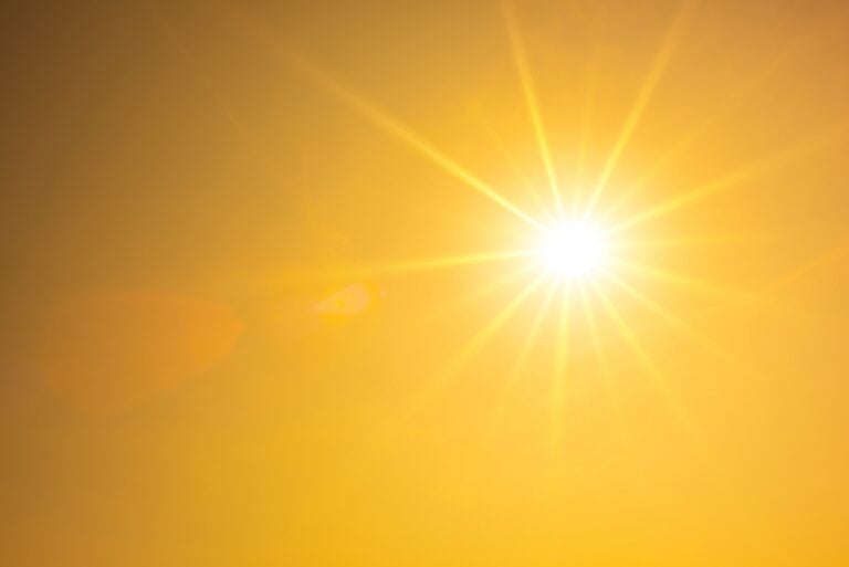 Hot summer or heat wave background, orange sky with glowing sun Summer background, orange sky with glowing sun