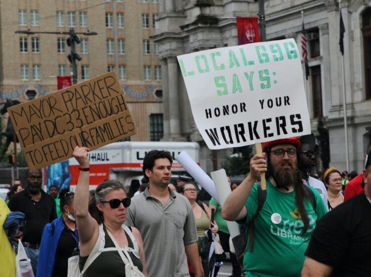Union members and supporters marched around City Hall