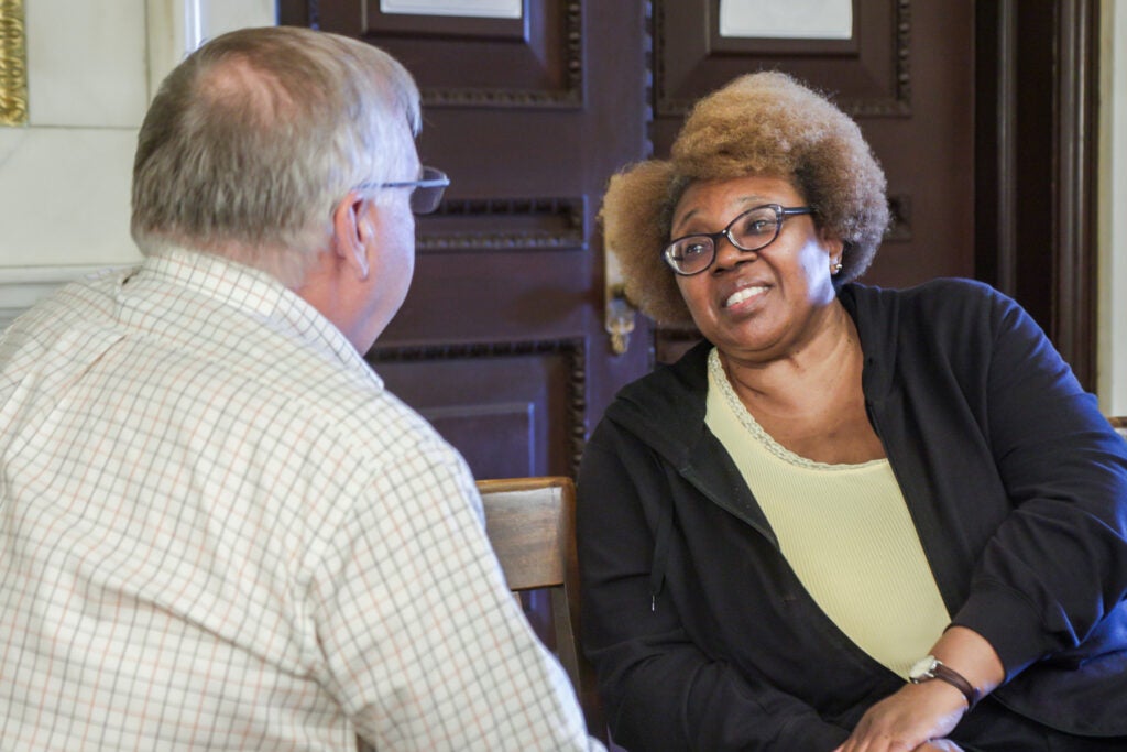 Two people sitting talking inside city hall