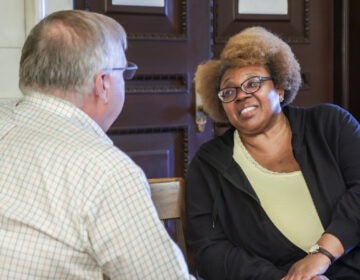 Two people sitting talking inside city hall