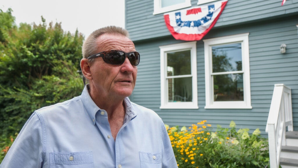 Donald Whiteman Jr., a lifelong resident of South Seaside Park, N.J., stands in front of a home
