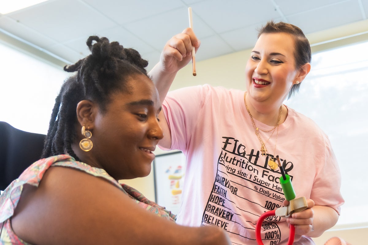 Rebecca Carpino (right) helps Candice Davis (left) assists with make up tools