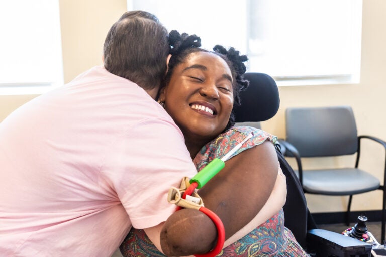Rebecca Carpino (left) hugs Candice Davis (right)