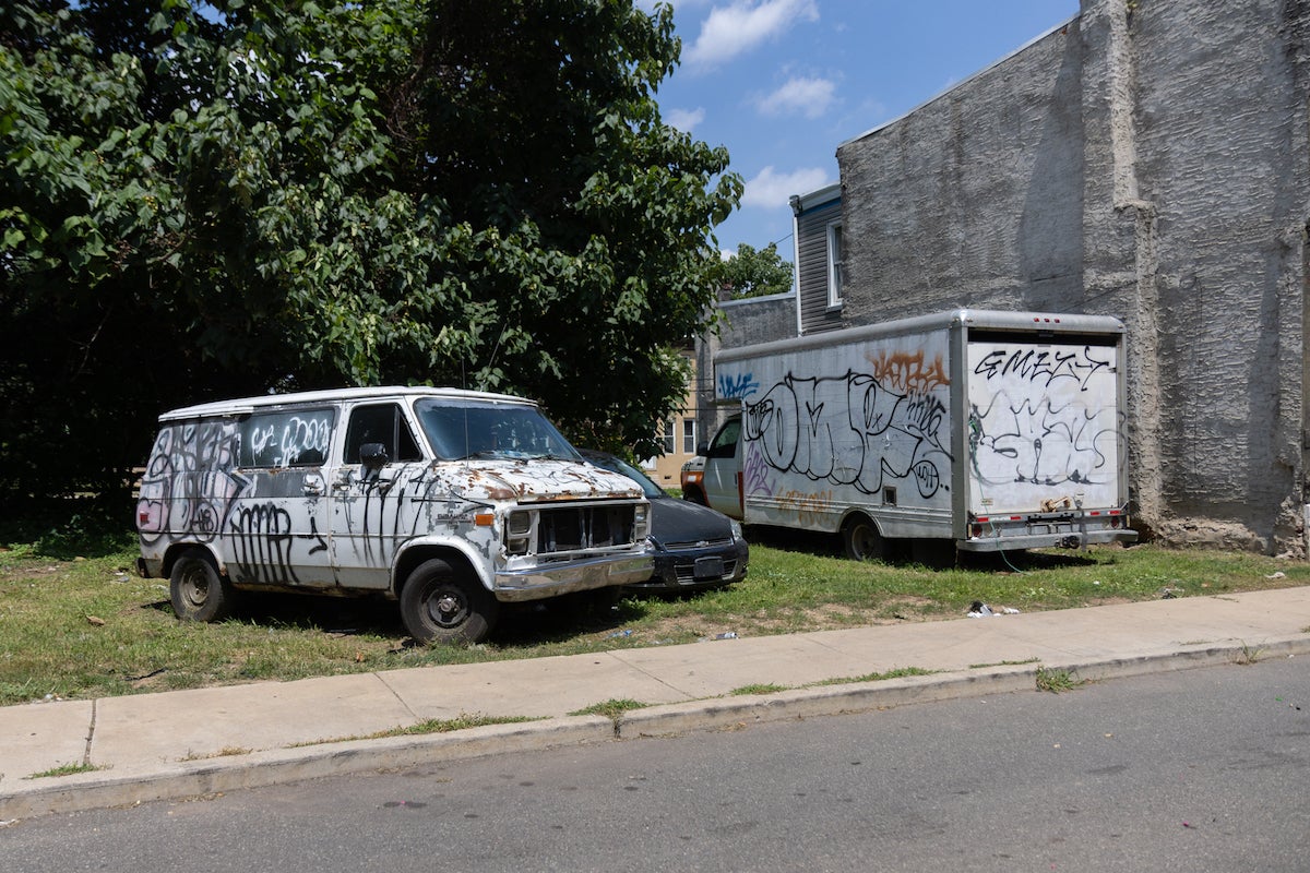 07 28 2025 k paynter w monmouth street-4 Abandoned vehicles on a lot in Philadelphia