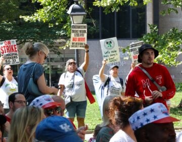 Striking municipal workers chant during Mayor Cherelle Parker's speech at the Celebration of Freedom ceremony at Independence Hall.