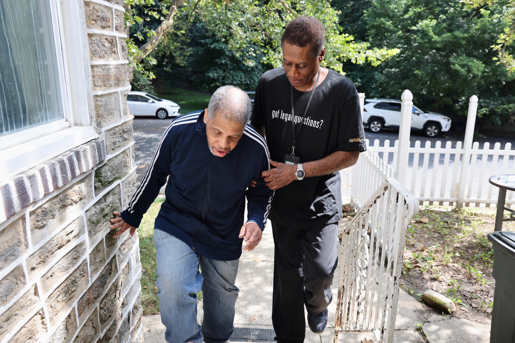 The Senior Companion Program's Joseph Dennis helps James Henry up the stairs