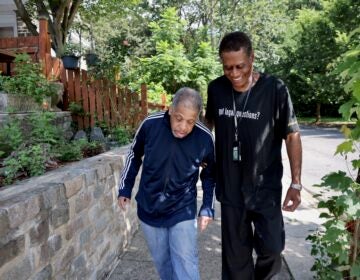 The Senior Companion Program's Joseph Dennis walks with James Henry