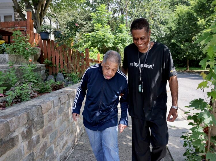 The Senior Companion Program's Joseph Dennis walks with James Henry