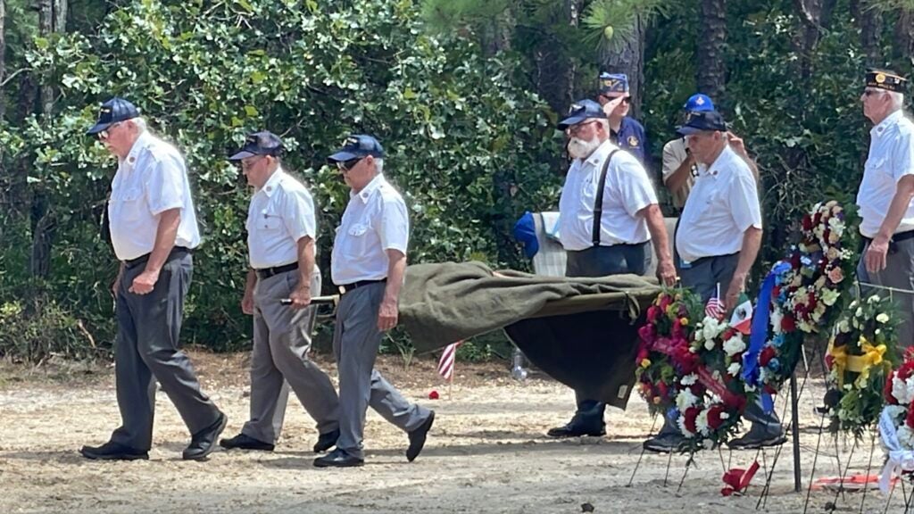 People re-enact the moment in 1928 when the remains of Mexican fighter pilot Emilio Carranza were recovered from the woods
