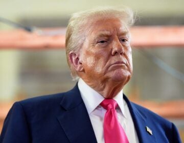 President Donald Trump looks on