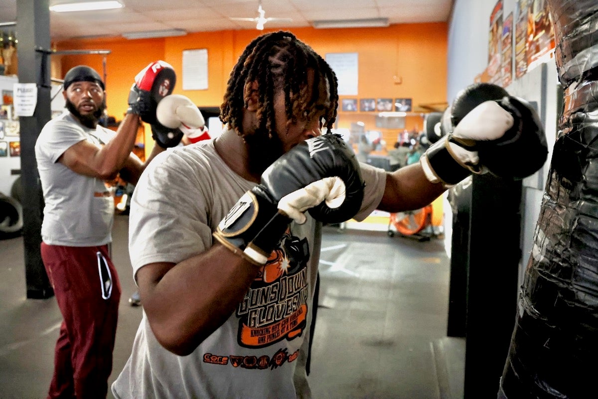 D'Andre Marks hits heavy bag at the Ike Williams Boxing Academy