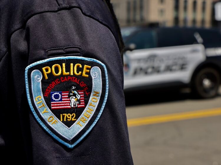 2025 07 24-e lee-trenton nj-police patch and cruiser A closeup photo of a Trenton police officer's badge on their arm.