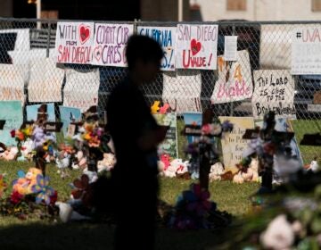 A woman visits a memorial honoring the victims killed in elementary school shooting in Uvalde, Texas, Friday, June 3, 2022. (AP Photo/Jae C. Hong)