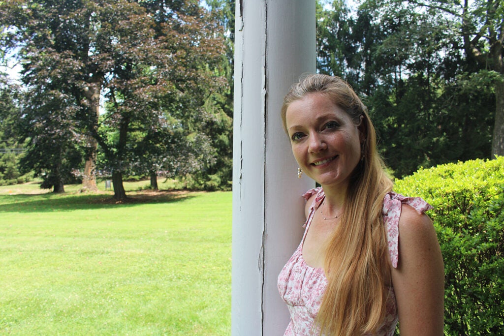 A woman smiles at the camera