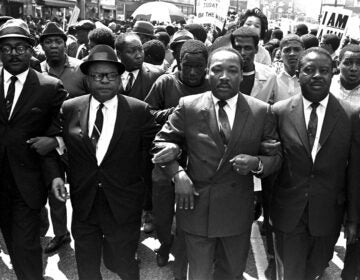 Ralph Abernathy and Bishop Julian Smith flank Dr. Martin Luther King during a civil rights march