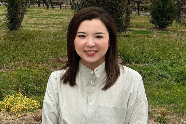 A woman smiles while posing for a photo