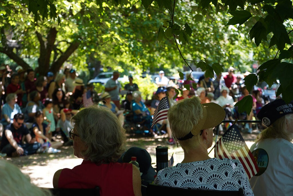 Mount Airy residents sit under the shade during a public reading of the Declaration of Independence.