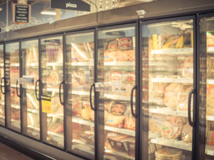 Blurry background frozen pizza in freezer at American supermarket