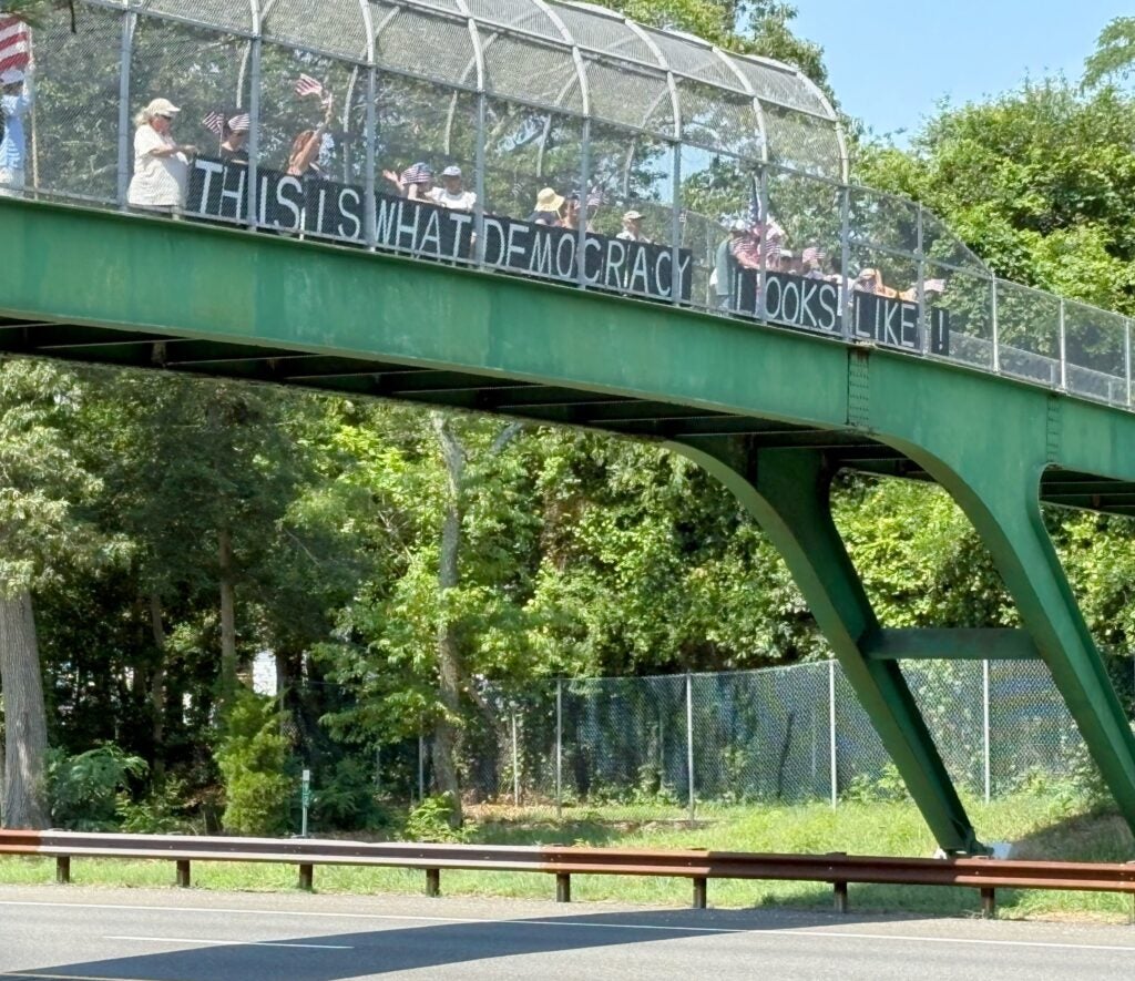 Members of the Bridge Brigade hold handmade signs