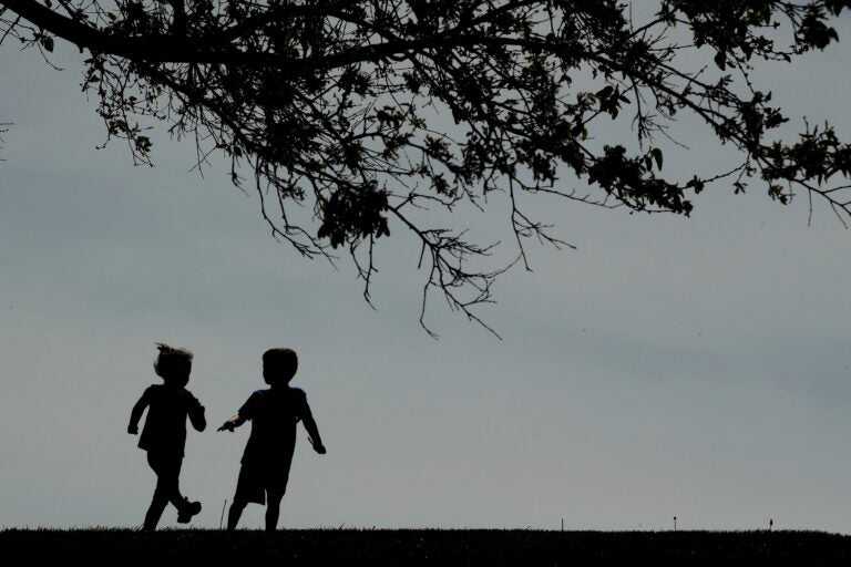 Children run on a lawn