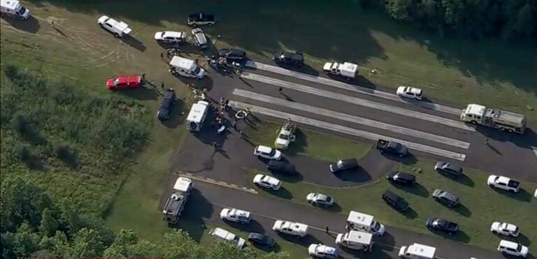 cross_keys_airport_plane_crash_07022025 A large number of vehicles for medical personnel and first responders sit on a runway at an airport following a report of a plane crash