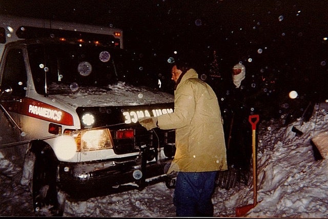People digging a vehicle out of the snow