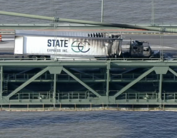A massive truck is seen by a barrier on the Delaware Memorial Bridge