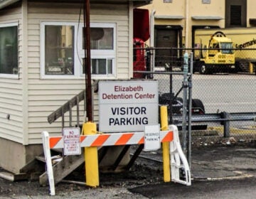 a sign reads Elizabeth Detention Center VISITOR PARKING