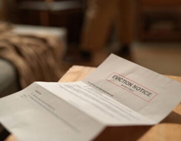 A eviction notice paper sits on a table