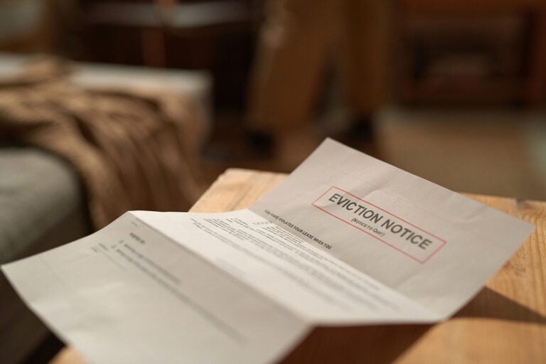 Room Eviction Notice Placed On Wooden Desk A eviction notice paper sits on a table