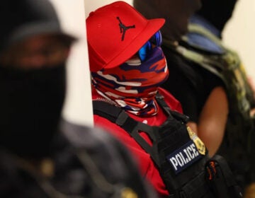 Federal agents wearing masks patroling