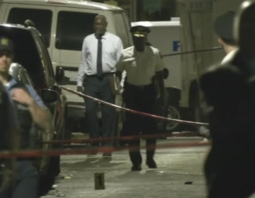 Police comb the scene of a mass shooting in Grays Ferry