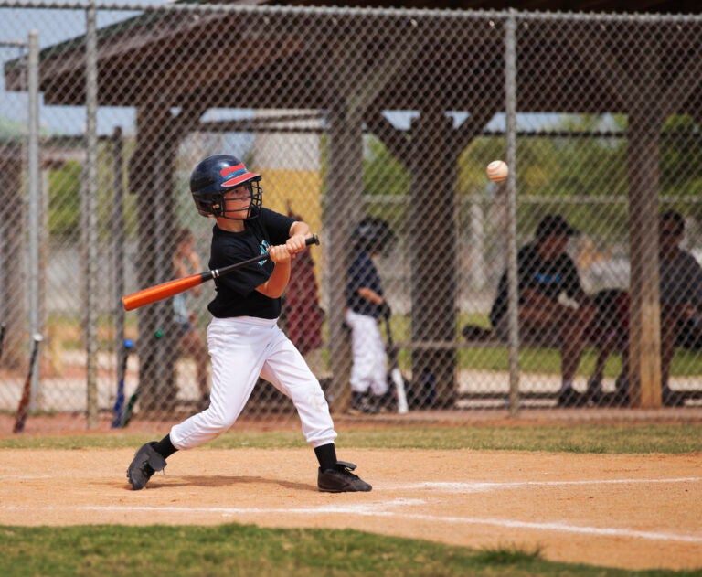 Baseball A Little League baseball player swings a bit