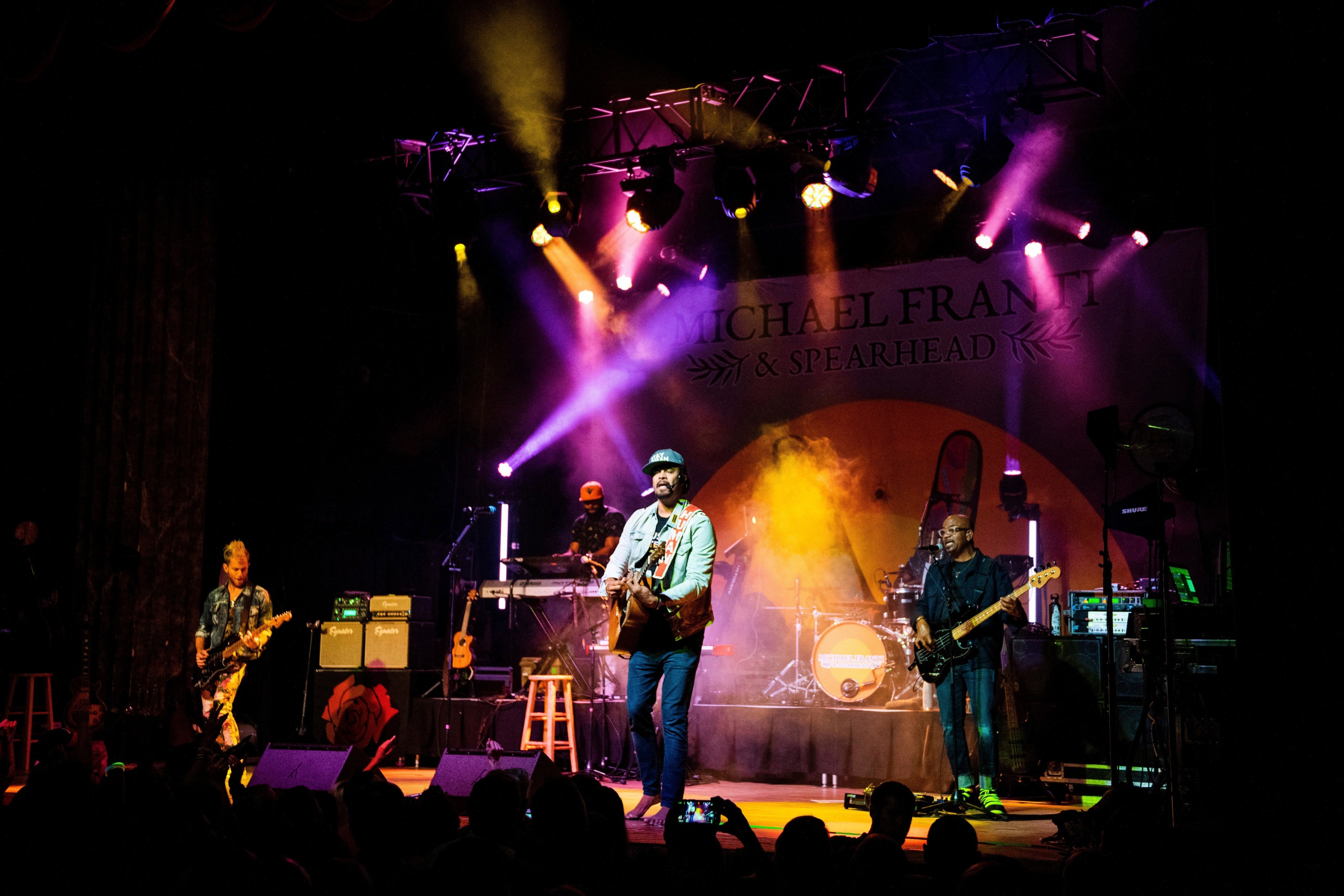 Michael Franti performs on stage