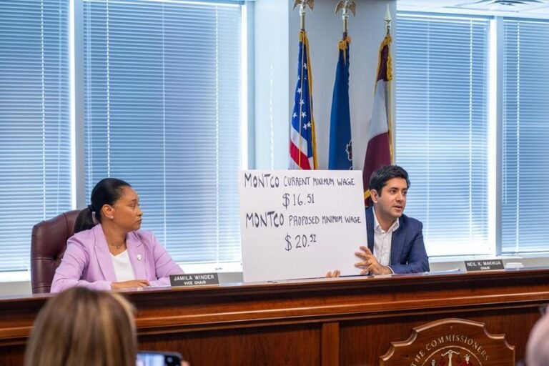 montco-minimum-wage-increase-courtesy-montco Montgomery County Commissioner Neil Makhija holds up a sign showing the previous starting minimum wage for county employees